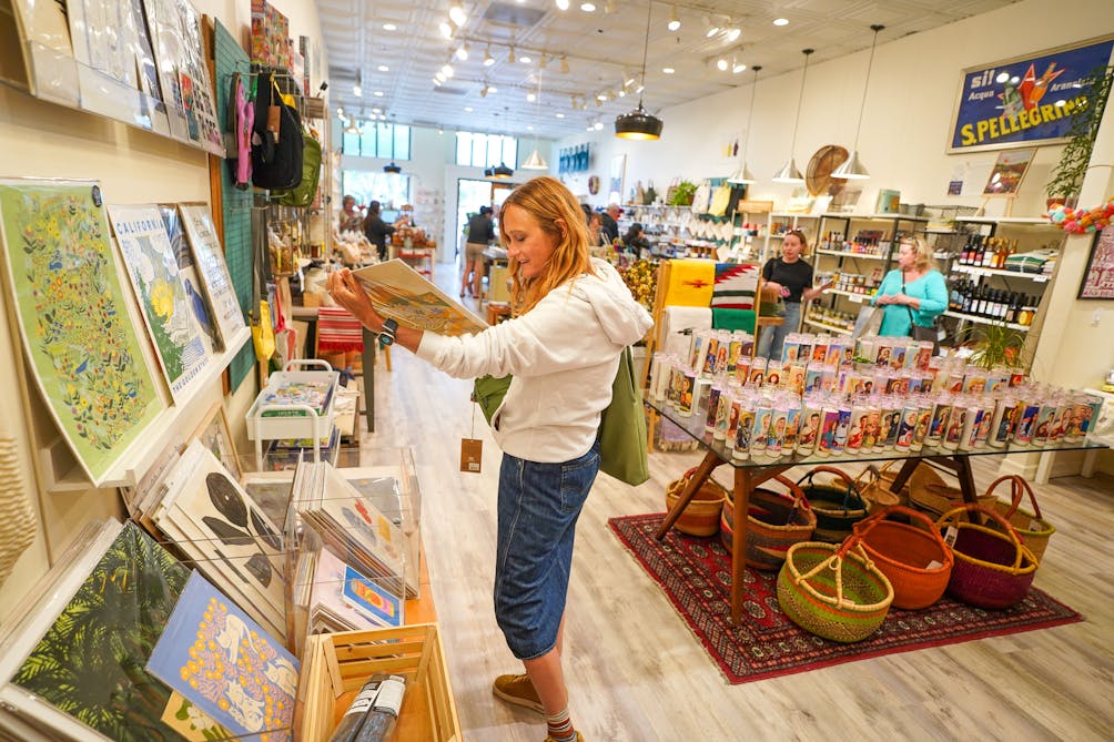 A woman looks at art deco posters inside The General Store located in downtown Paso Robles 