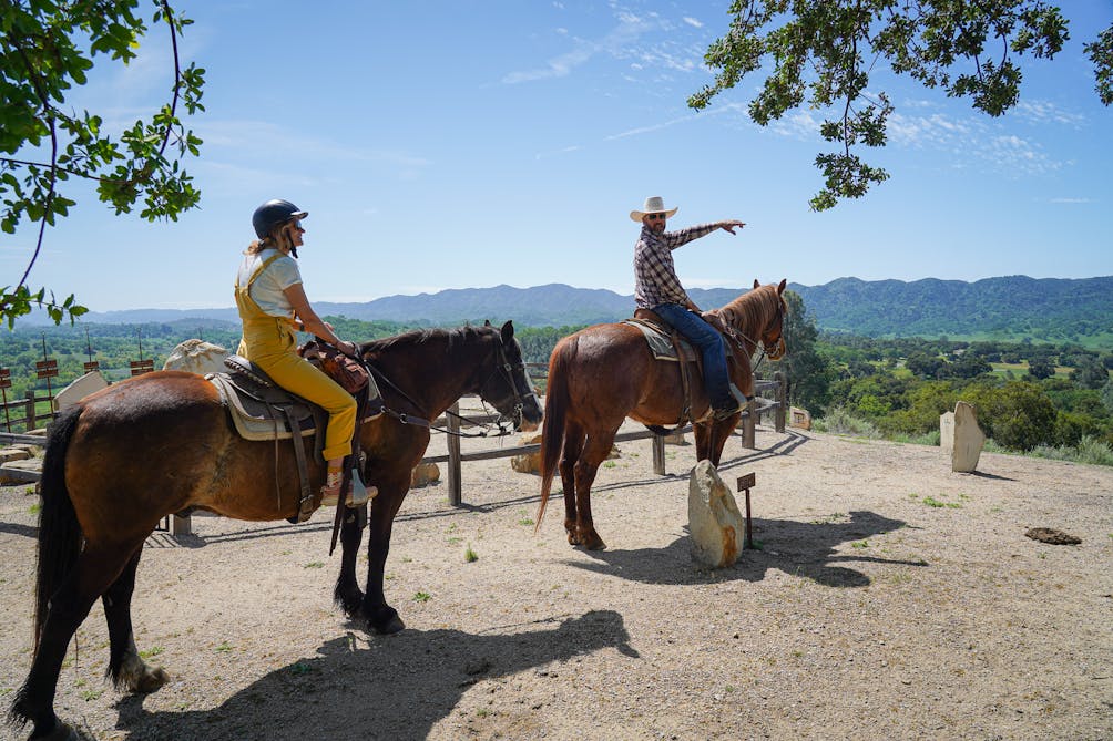 Two people on a horse at a sundial at Santa Margarita Ranch in Paso Robles