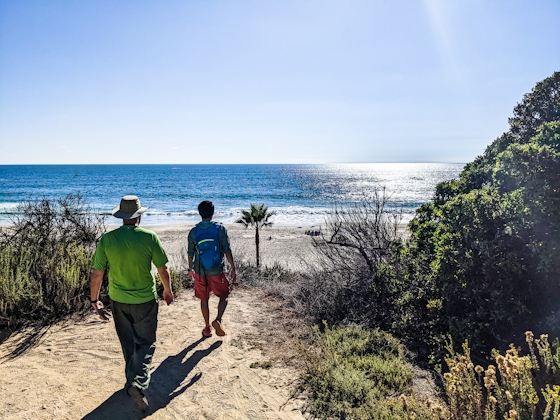 Two people walking towards Salt Creek Beach in Dana Point Orange County 