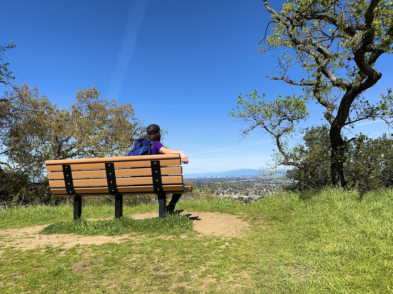 Pearson sitting on a bench atop a high point at Almaden Quicksilver County Park 