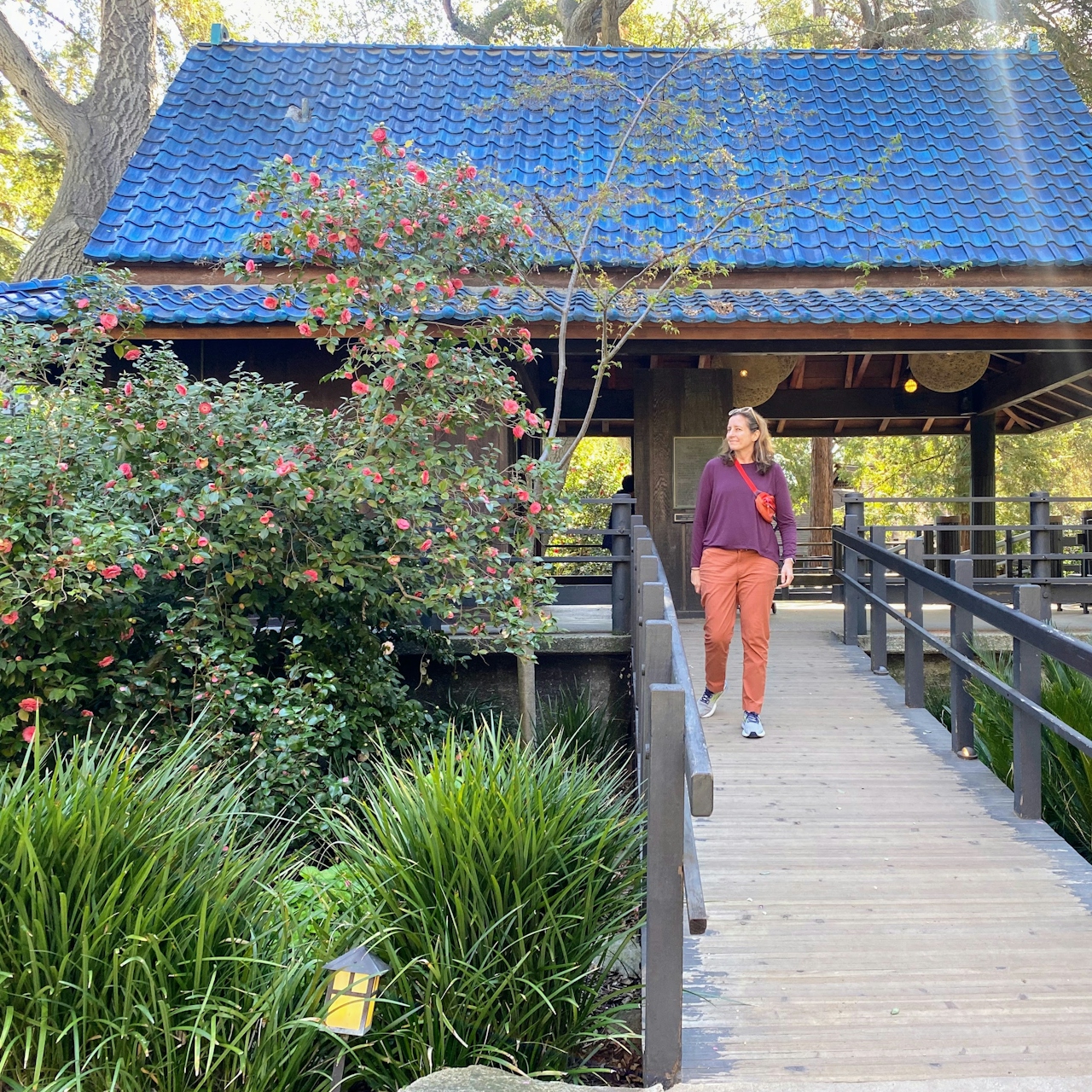 A woman is walking a pathway at Descanso Gardens in Los Angeles